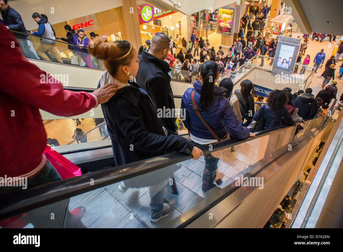 Crowds of last minute shoppers pack the Queens Center Mall in the