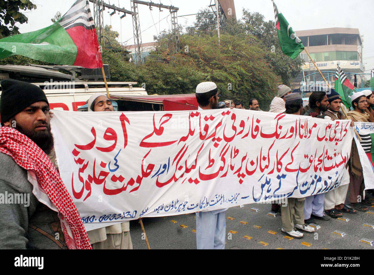 Activists of Ahle Sunnat Wal Jamat (Defunct Sipah-e-Sahaba)  chant slogans against an assassination attack on leader Aurangzeb Farooqi convoy and killing of  his seven gunmen including driver during a protest demonstration at Lahore press club on  Wednesday, December 26, 2012. Stock Photo