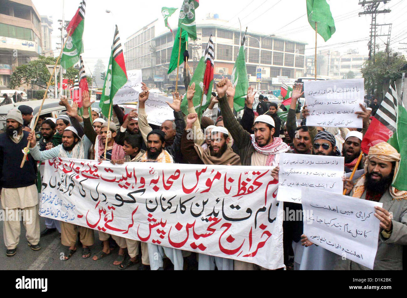 Activists of Ahle Sunnat Wal Jamat (Defunct Sipah-e-Sahaba)  chant slogans against an assassination attack on leader Aurangzeb Farooqi convoy and killing of  his seven gunmen including driver during a protest demonstration at Lahore press club on  Wednesday, December 26, 2012 Stock Photo