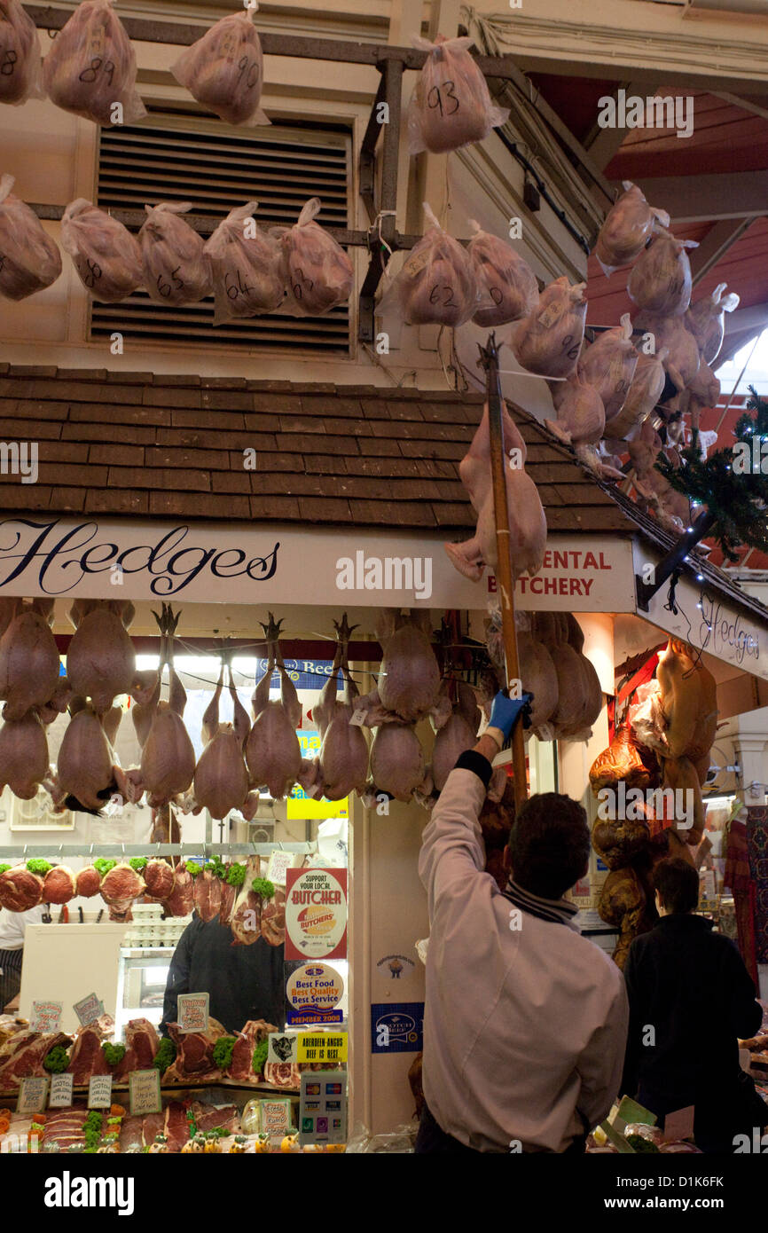 butchers hanging turkeys in the oxford covered market at christmas Stock Photo