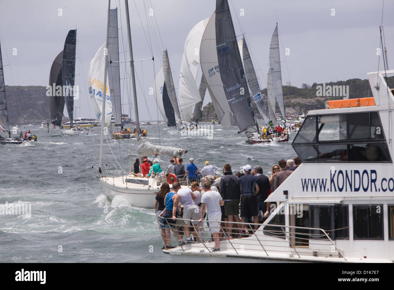 spectators watch the sydney to hobart yacht race 2012 commence as the yachts make their way to spectators watch the sydney to hobart yacht race 2012 commence as the yachts make their way to