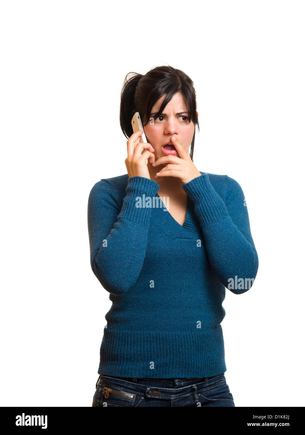 Worried young woman talking on mobile phone Stock Photo