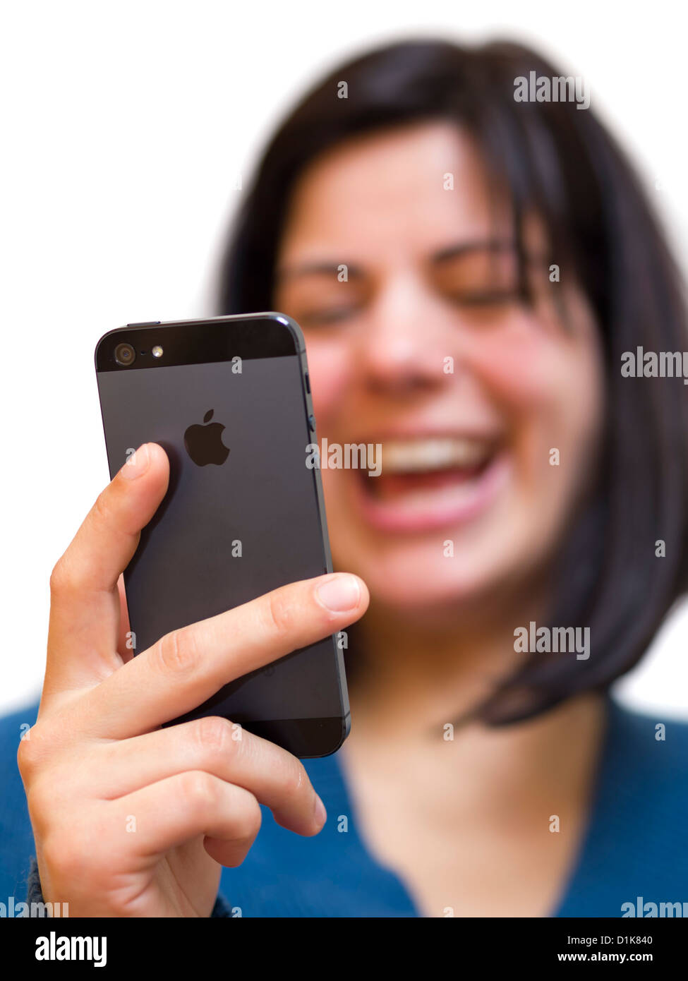 Smiling young woman holding an iPhone 5 Stock Photo