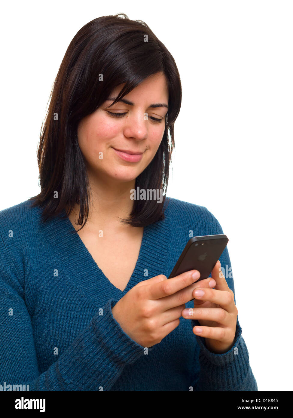 Smiling young woman texting on an iPhone 5 Stock Photo