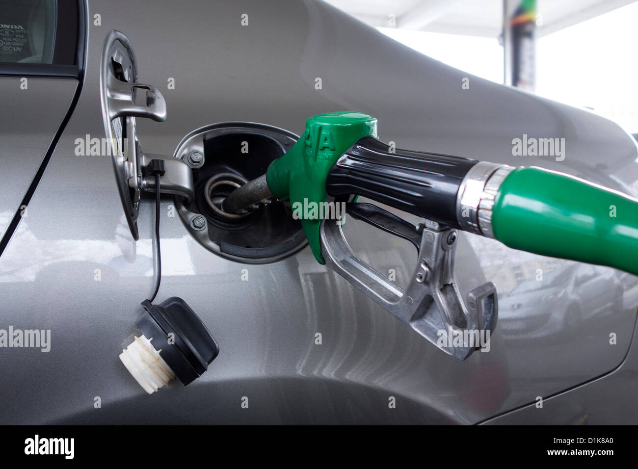 Close up of gas pump nozzle filling up car Stock Photo