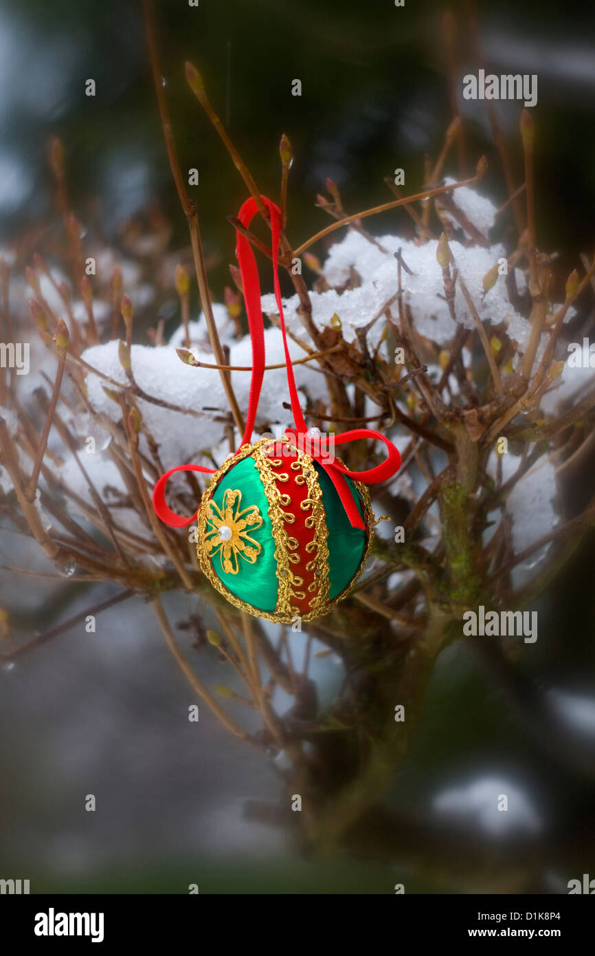 WA06231-00...WASHINGTON - Christmas ornament hanging on a snow covered decorating the outdoors. Stock Photo