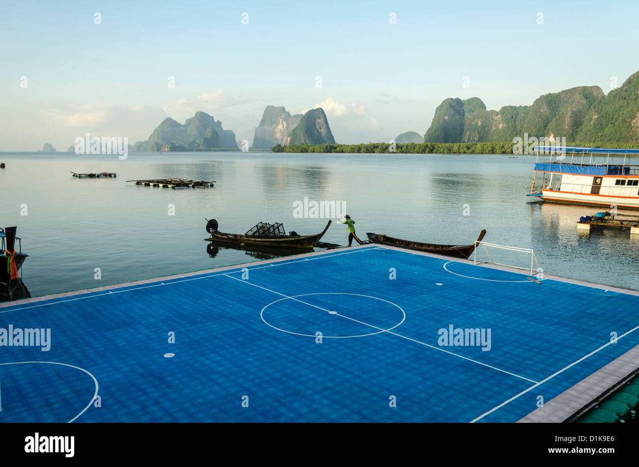 Floating soccer field at Ko Panyi Muslim stilt village with Ao Phang-Nga Marine National Park in background in southern Thailand Stock Photo
