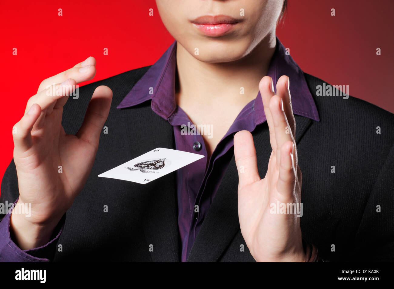 Cropped shot of a magician with a playing card floating between his
