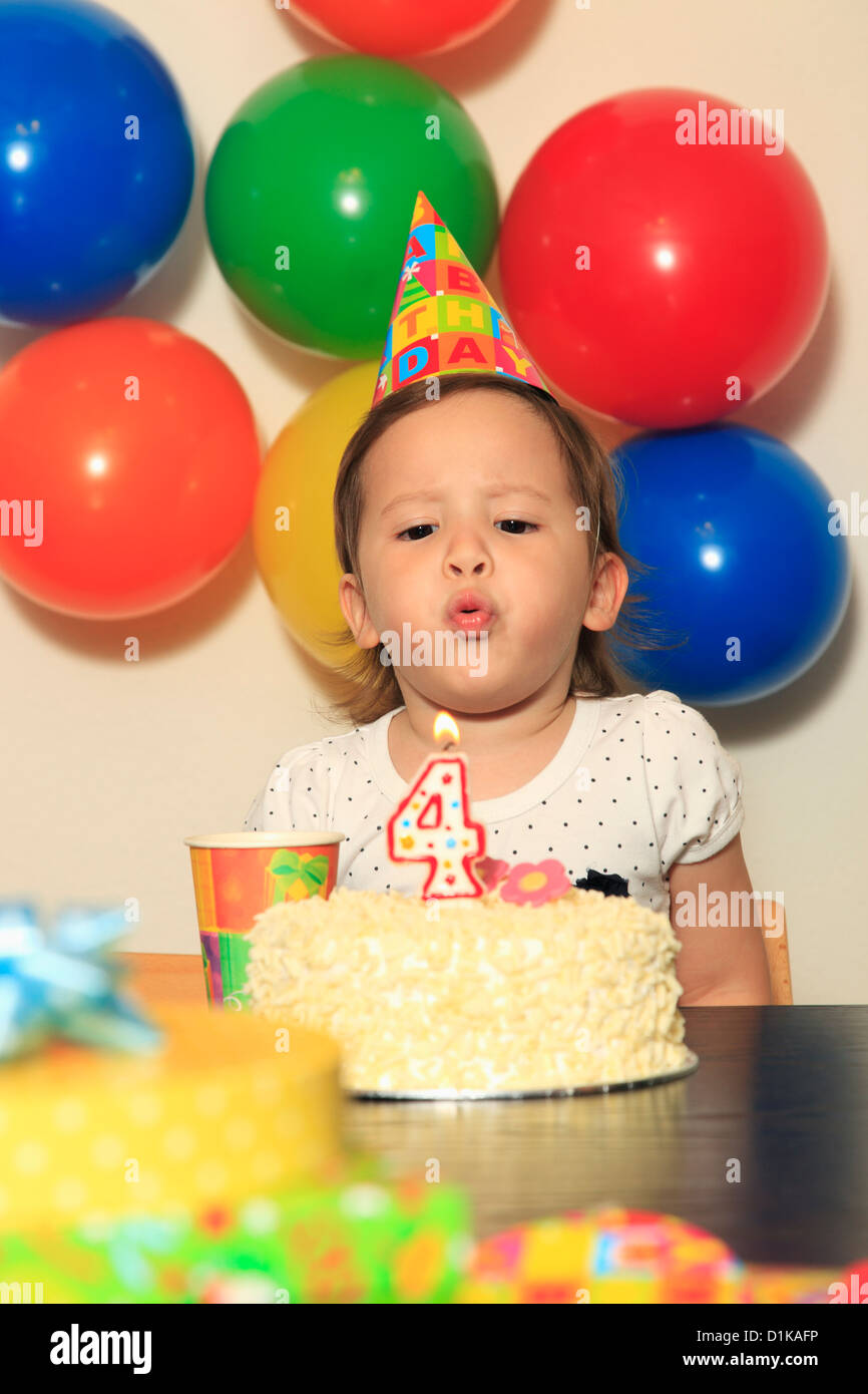 Young girl blowing out a candle on her birthday cake Stock Photo Alamy