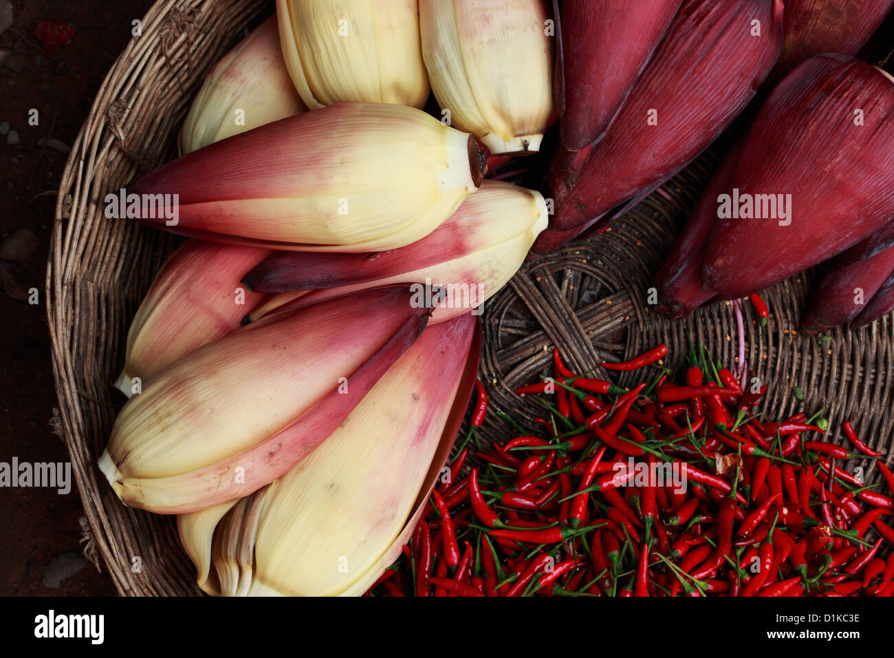 Banana flowers and chillies in woven basket, Cambodia Stock Photo