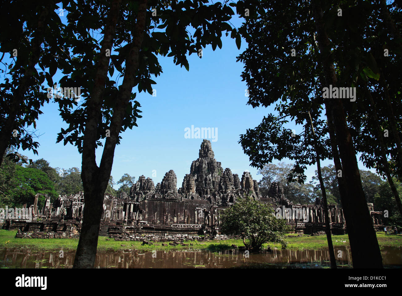 View of Bayon Temple through trees, Angkor Wat, Cambodia Stock Photo