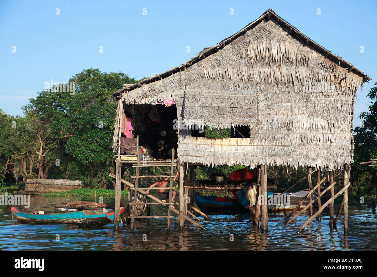 Thatched house on stilts in a river, Angkor Wat, Cambodia Stock Photo