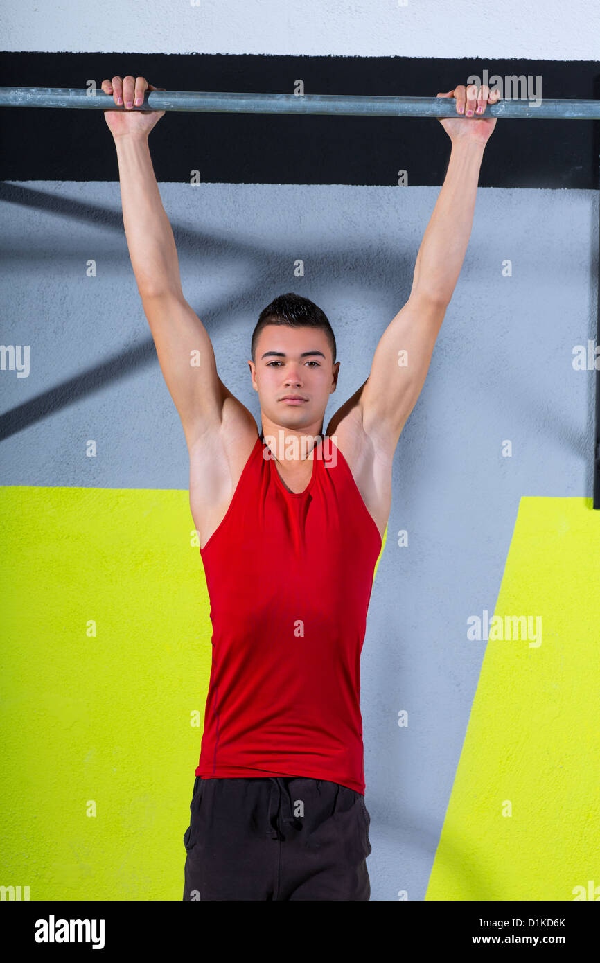 Crossfit toes to bar young man pullups 2 bars workout exercise at gym