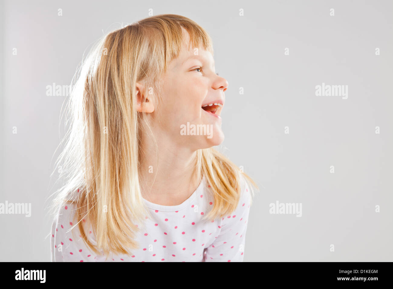 Studio portrait of happy smiling young girl Stock Photo - Alamy