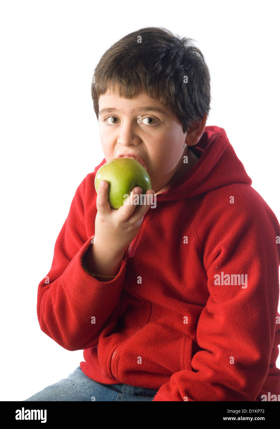 boy eating a green apple on the playground Stock Photo Alamy