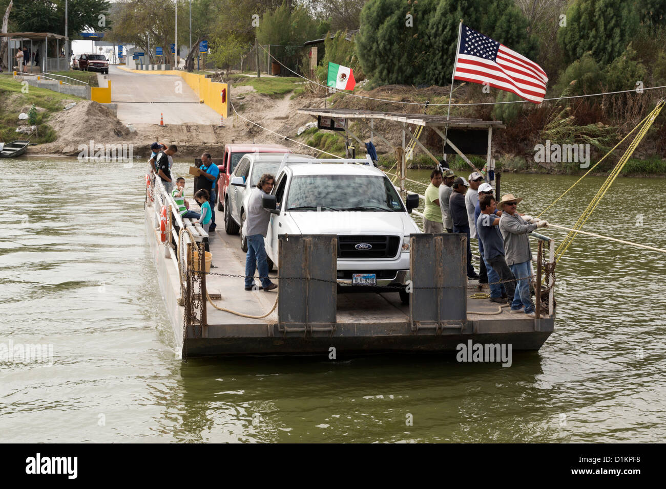 The Los Ebanos Ferry traversing the Rio Grande River from Mexico to Los Ebanos, TX, USA Stock Photo