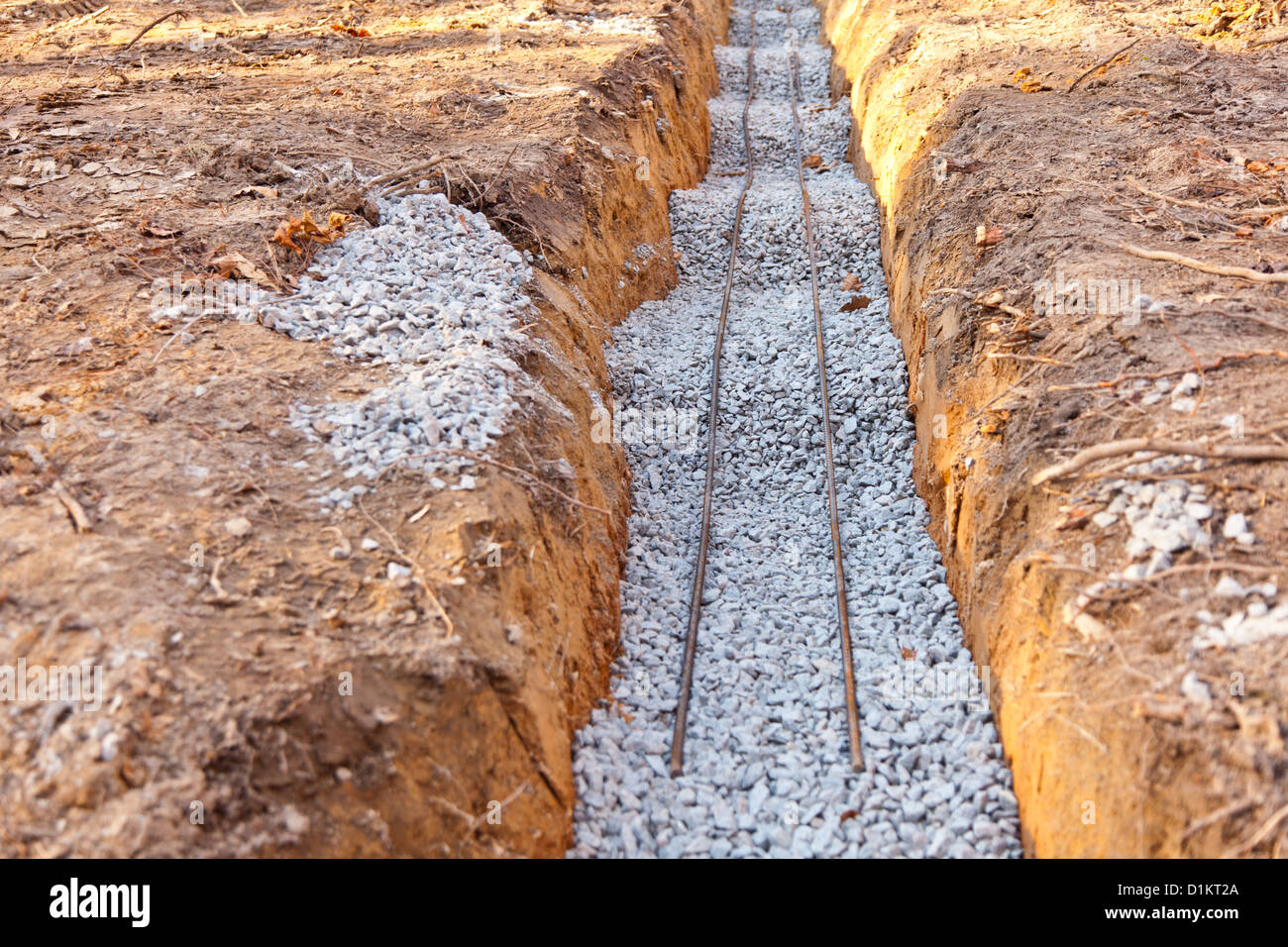 Trench filled with gravel and rebar on top in preparation for house