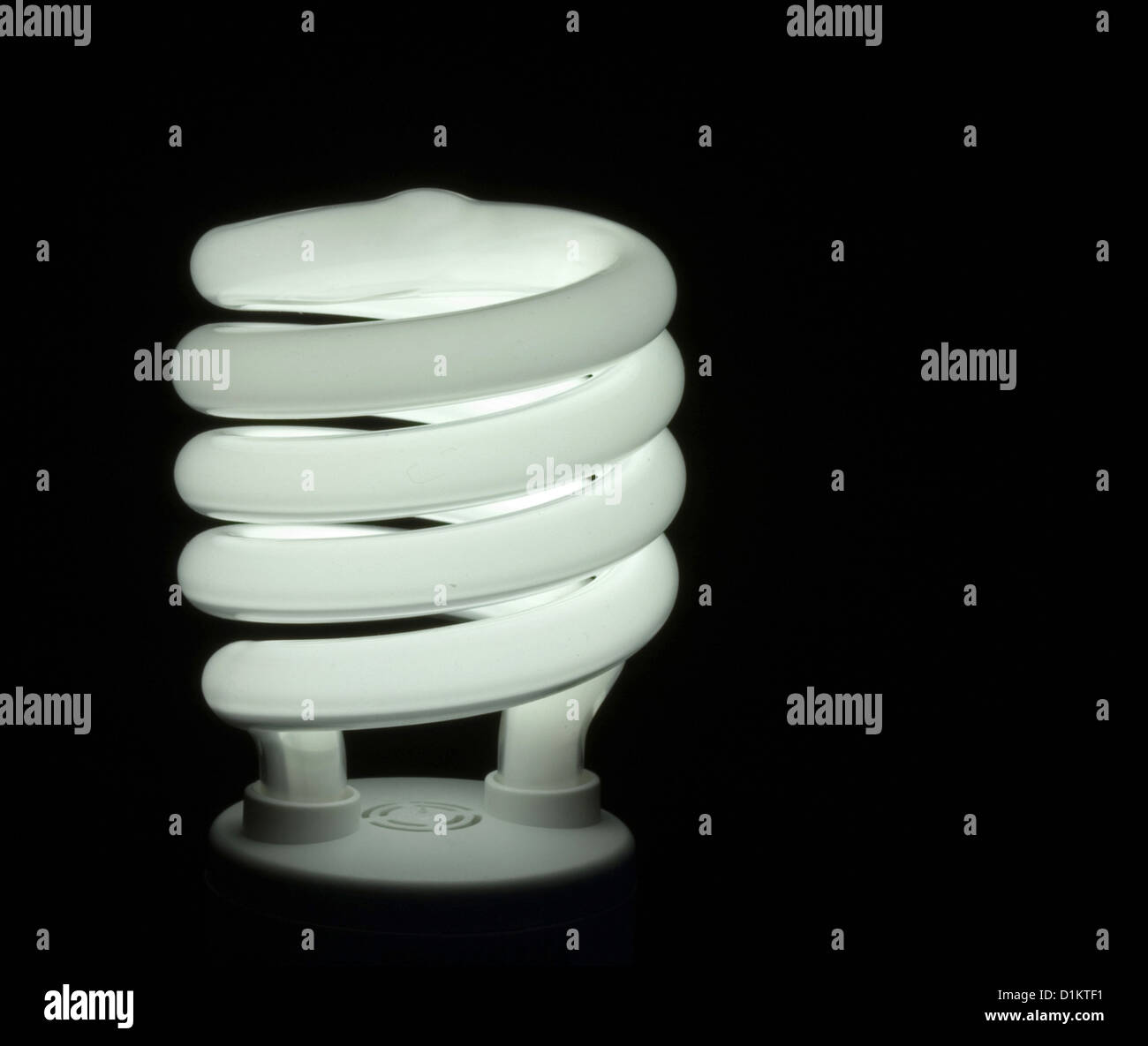 Energy efficient fluorescent light bulb on black background Stock Photo