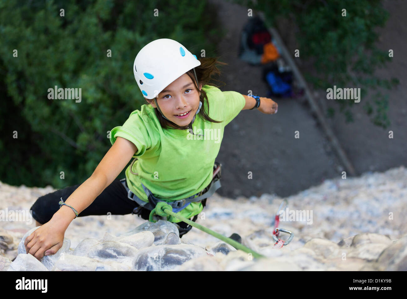 Mixed race girl rock climbing Stock Photo