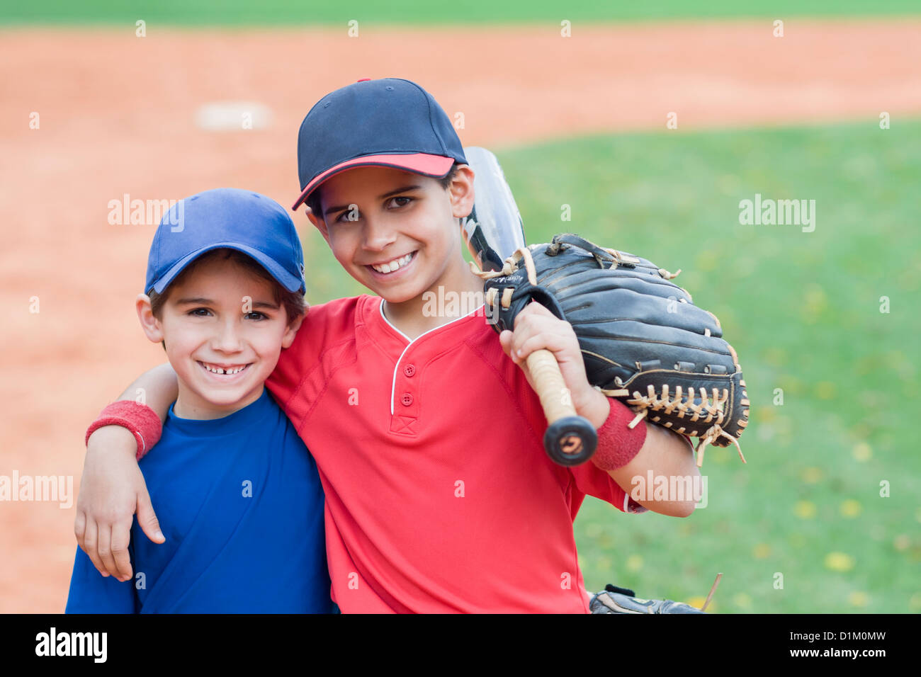 Hispanic boys in baseball uniforms hires stock photography and images