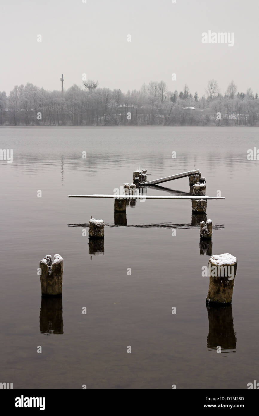 Remaining of old bridge, winter scenery, lake Czos, Mragowo, Poland Stock Photo
