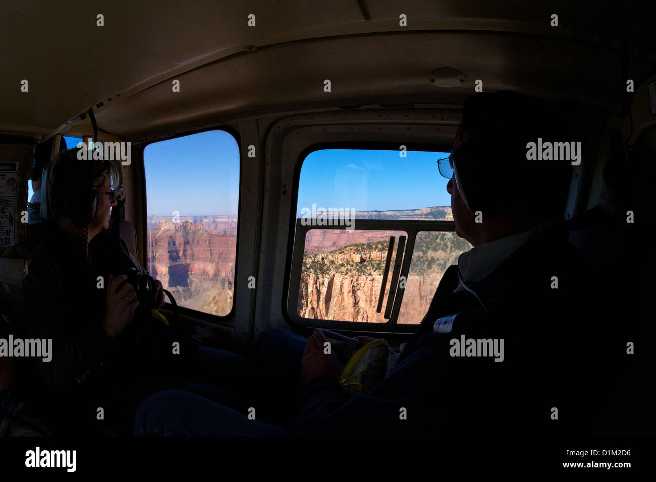 Tourists admire views of Grand Canyon from Papillon Helicopter, Grand Canyon National Park, Arizona, USA Stock Photo