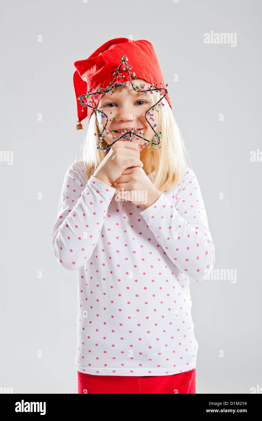 Studio Portrait Of Smiling Young Girl Wearing Red Christmas