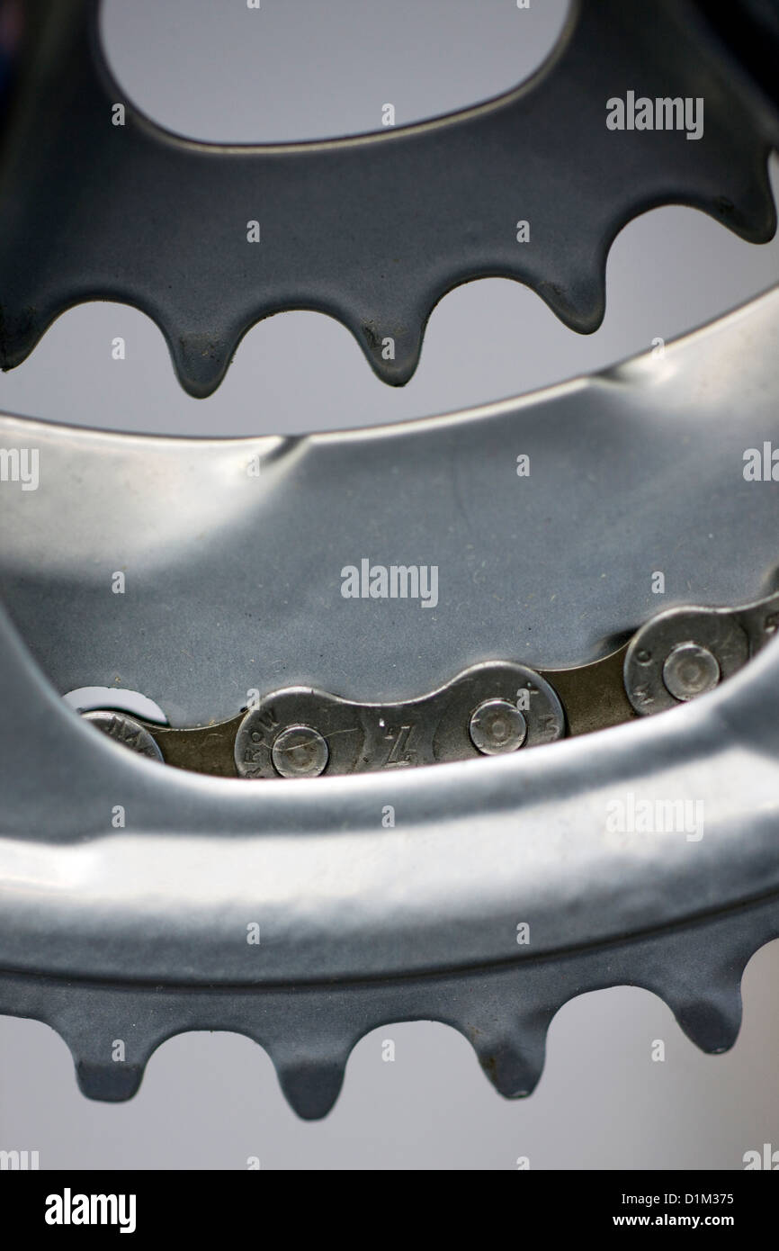 Close up of crankset showing chainring and bike chain, parts of bicycle