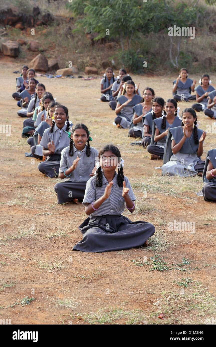 School children singing and clapping hands Andhra Pradesh South India Stock Photo