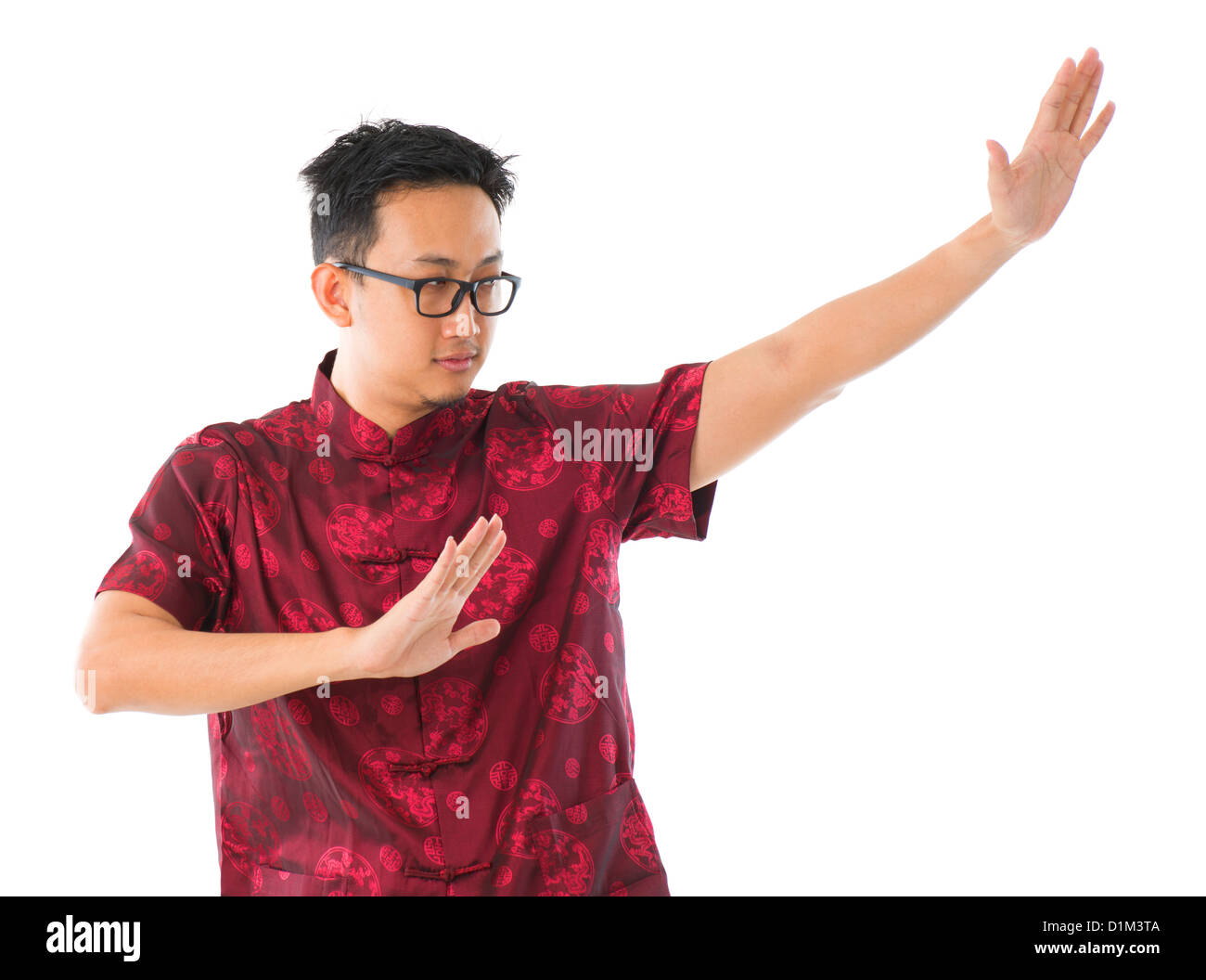 Southeast Asian Chinese man practicing tai chi, isolated on white background Stock Photo