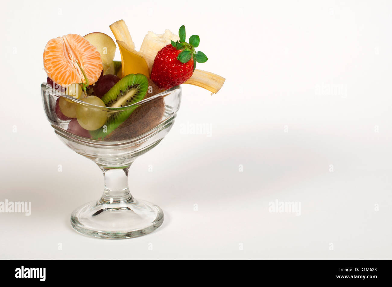 Fruit salad in a glass bowl on white background Stock Photo - Alamy