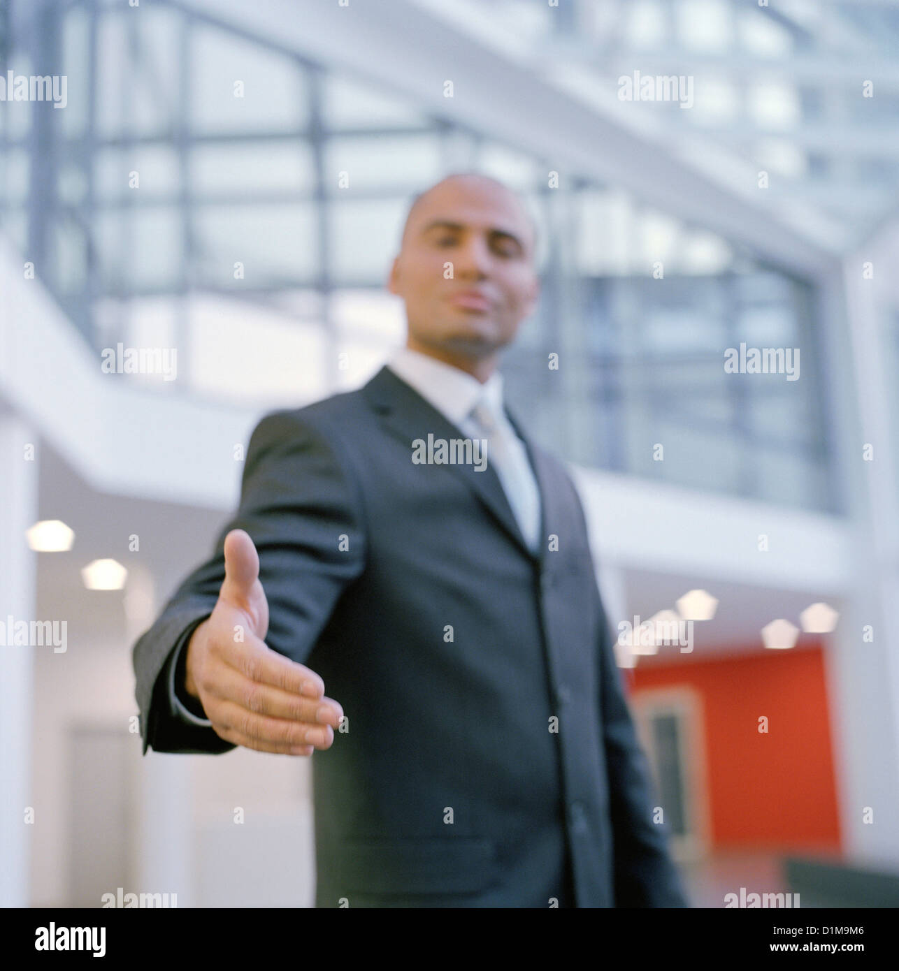 Charismatic businessman holding out his hand License free except ads and billboards Stock Photo