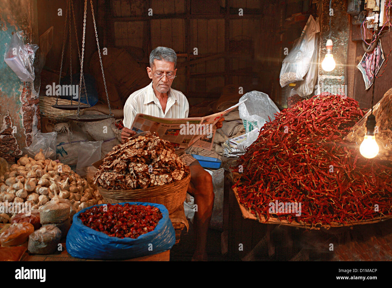 Man selling traditional dried chillies Stock Photo