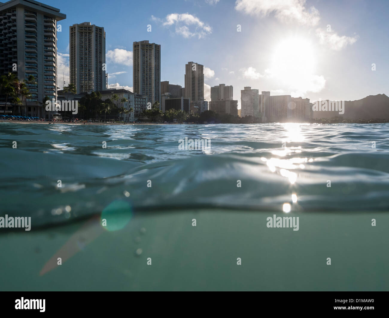Partial underwater shot of Waikiki resorts and Diamond Head Peak shortly after sunrise. Stock Photo