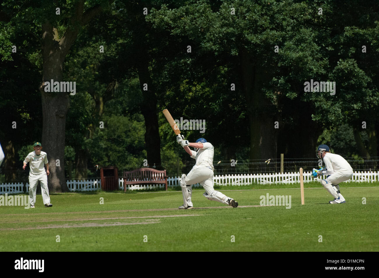 Game of cricket on a summers afternoon in an English village. Stock Photo