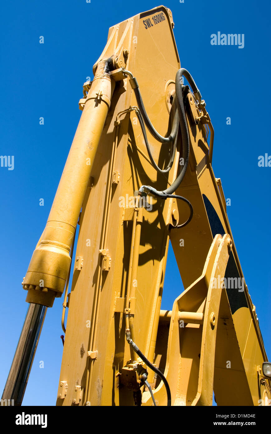 The mechanical arm of a backhoe, complete with hydraulic hoses Stock