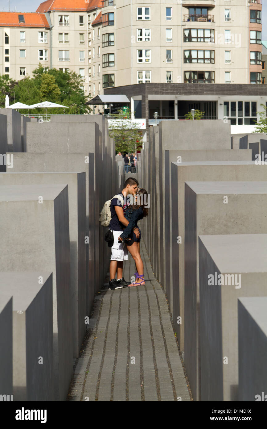 Young Couple kissing in the Memorial to the Murdered Jews of Europe ( Holocaust Memorial ) in Berlin Mitte, Germany Stock Photo