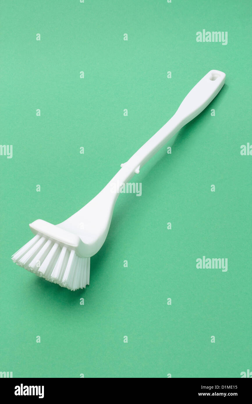 White Toilet Bowl Brush Lying on Green Background Stock Photo - Alamy