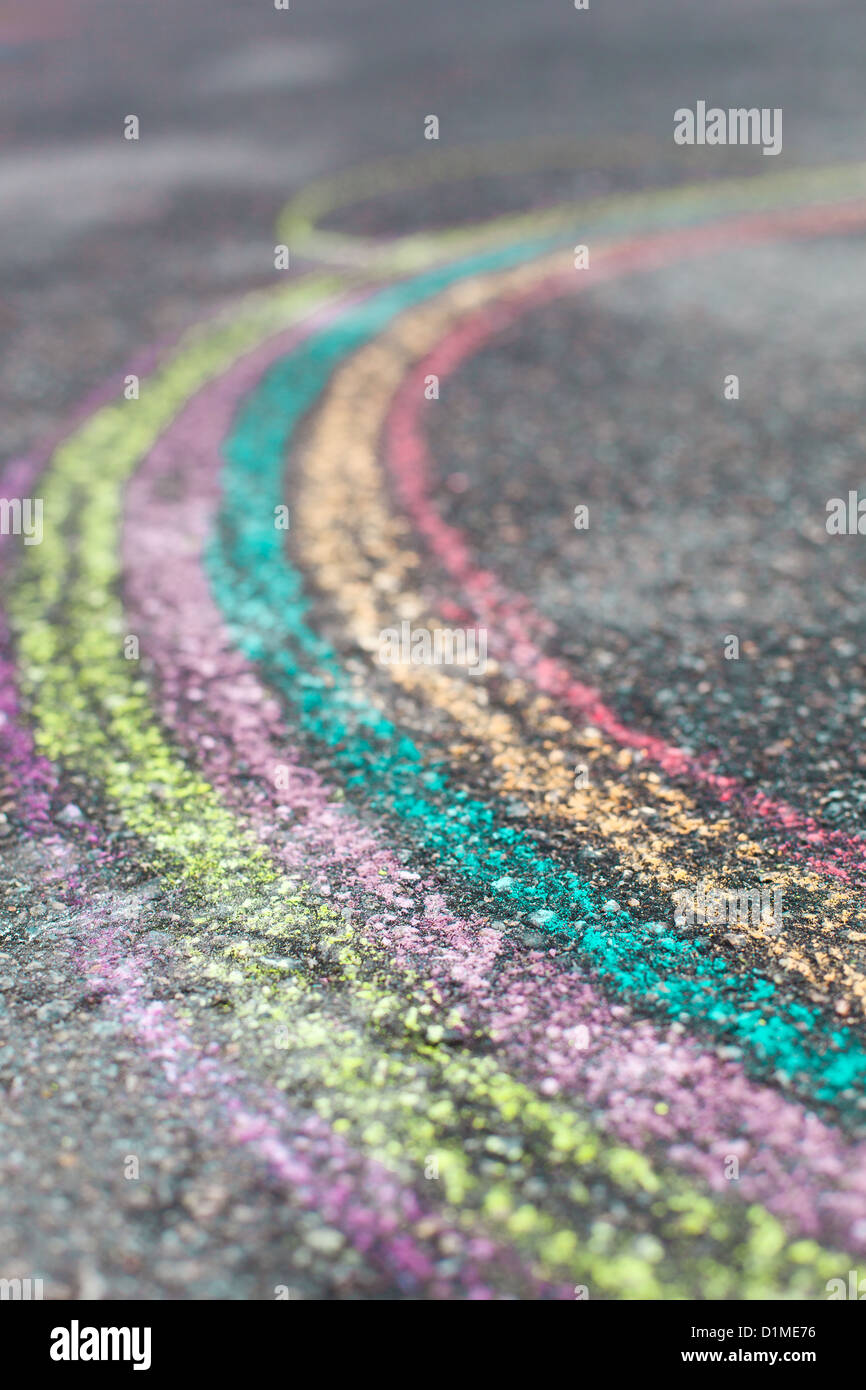 chalk drawing of rainbow and color chalks on asphalt Stock Photo