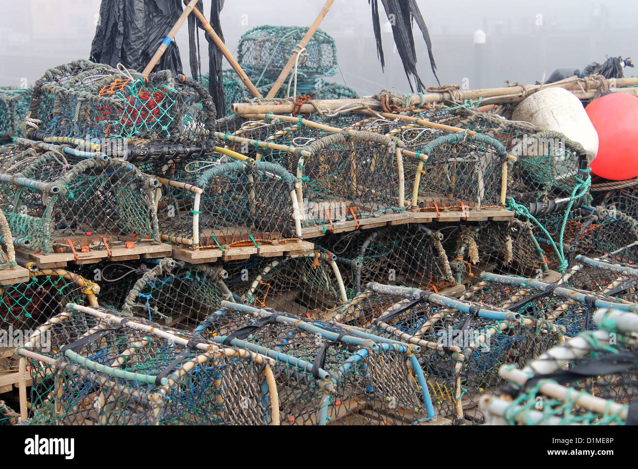 Lobster pots and creels in Scarborough harbor with fog background, England. Stock Photo