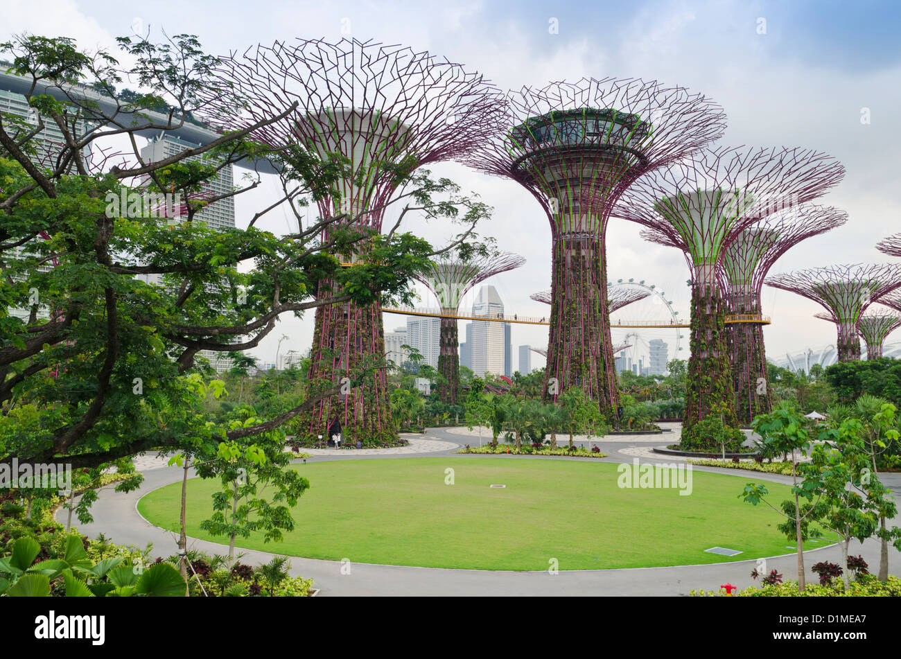The Supertree Grove at Gardens by the Bay with the Marina Bay Sands in the background, Singapore Stock Photo