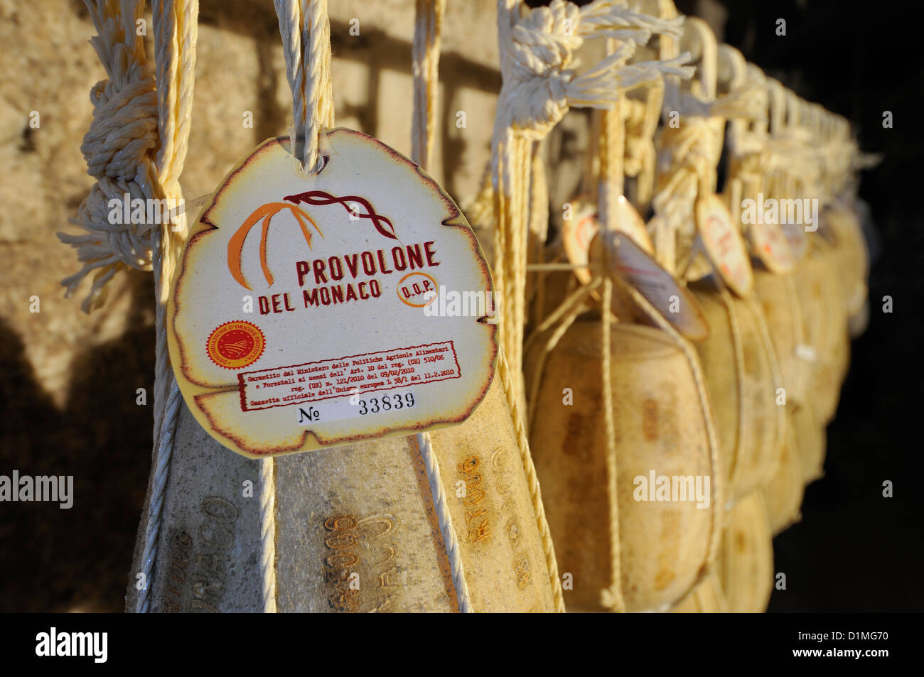 Vico Equense. Italy. Provolone del Monaco cheese hanging in cellar