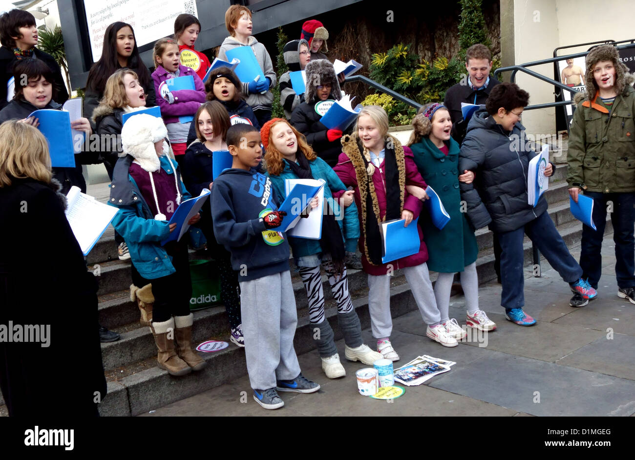 Children's choir sing Christmas carols in London street to raise funds Stock Photo
