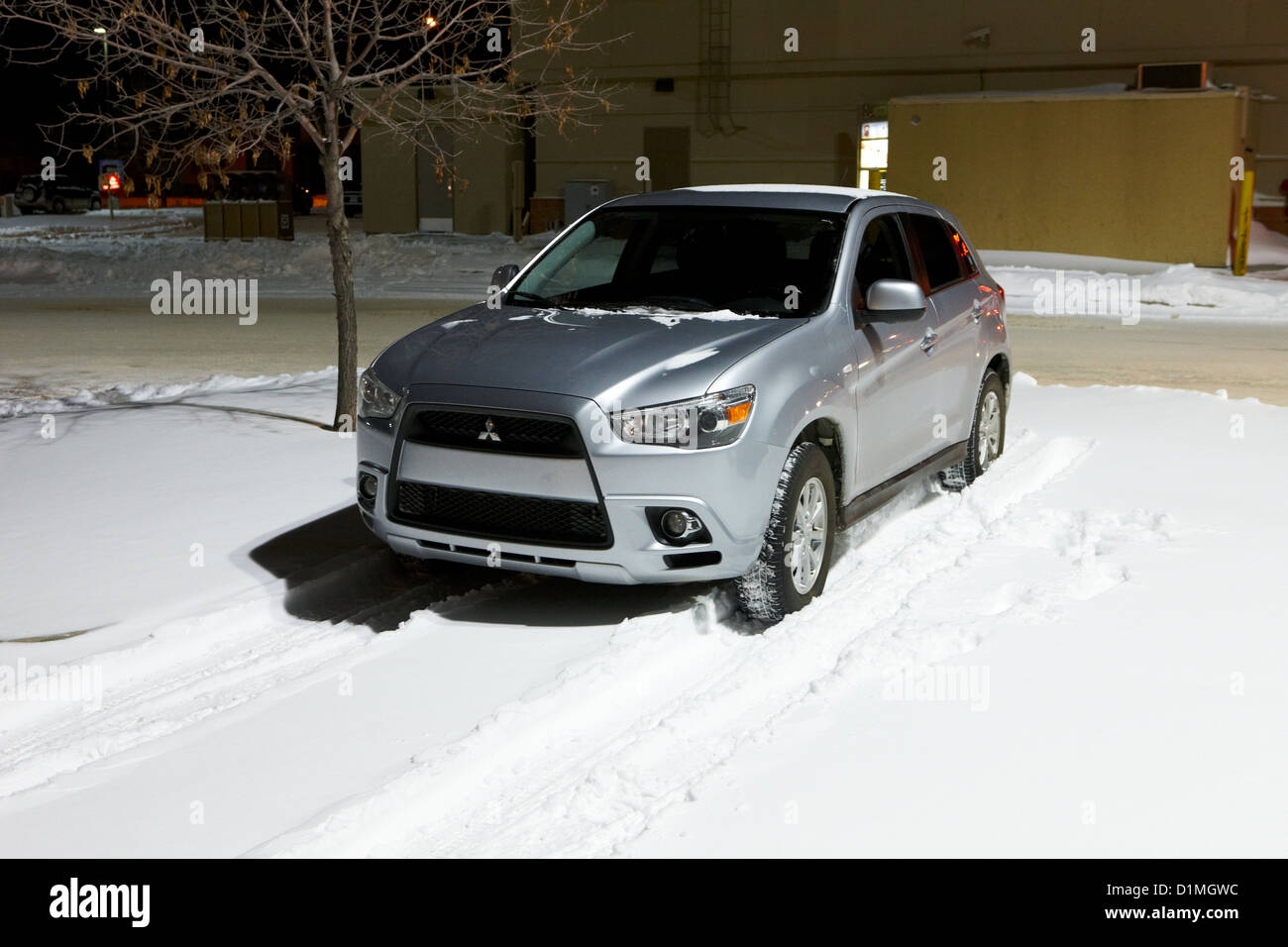 car parked in deepening snow in outdoor parking lot in Saskatoon