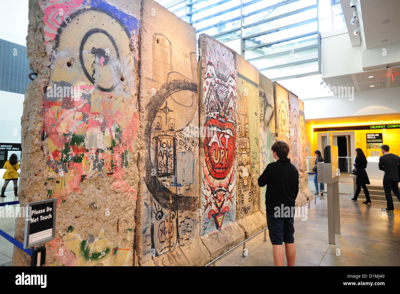 USA, Washington DC Museums Newseum museum of the news - section of the Berlin Wall being viewed by a boy tourist 14 Stock Photo
