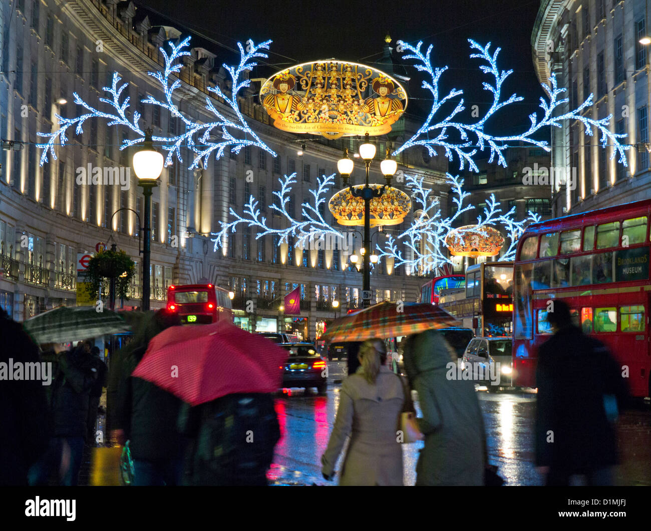 Busy scene of Christmas shoppers, traffic and umbrellas in a rain swept