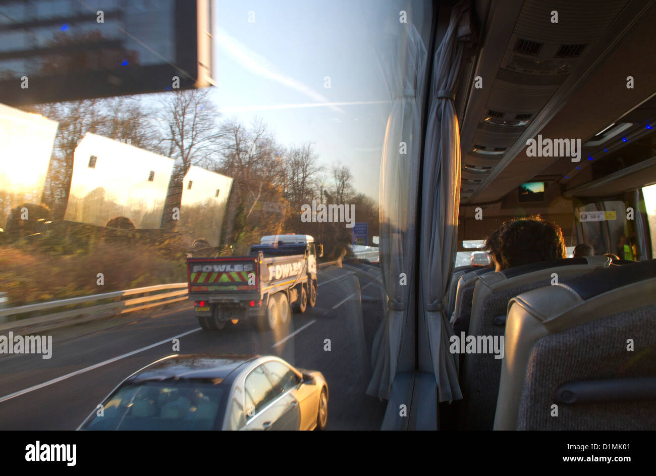 Man on coach looking out of the window at the motorway. Stock Photo