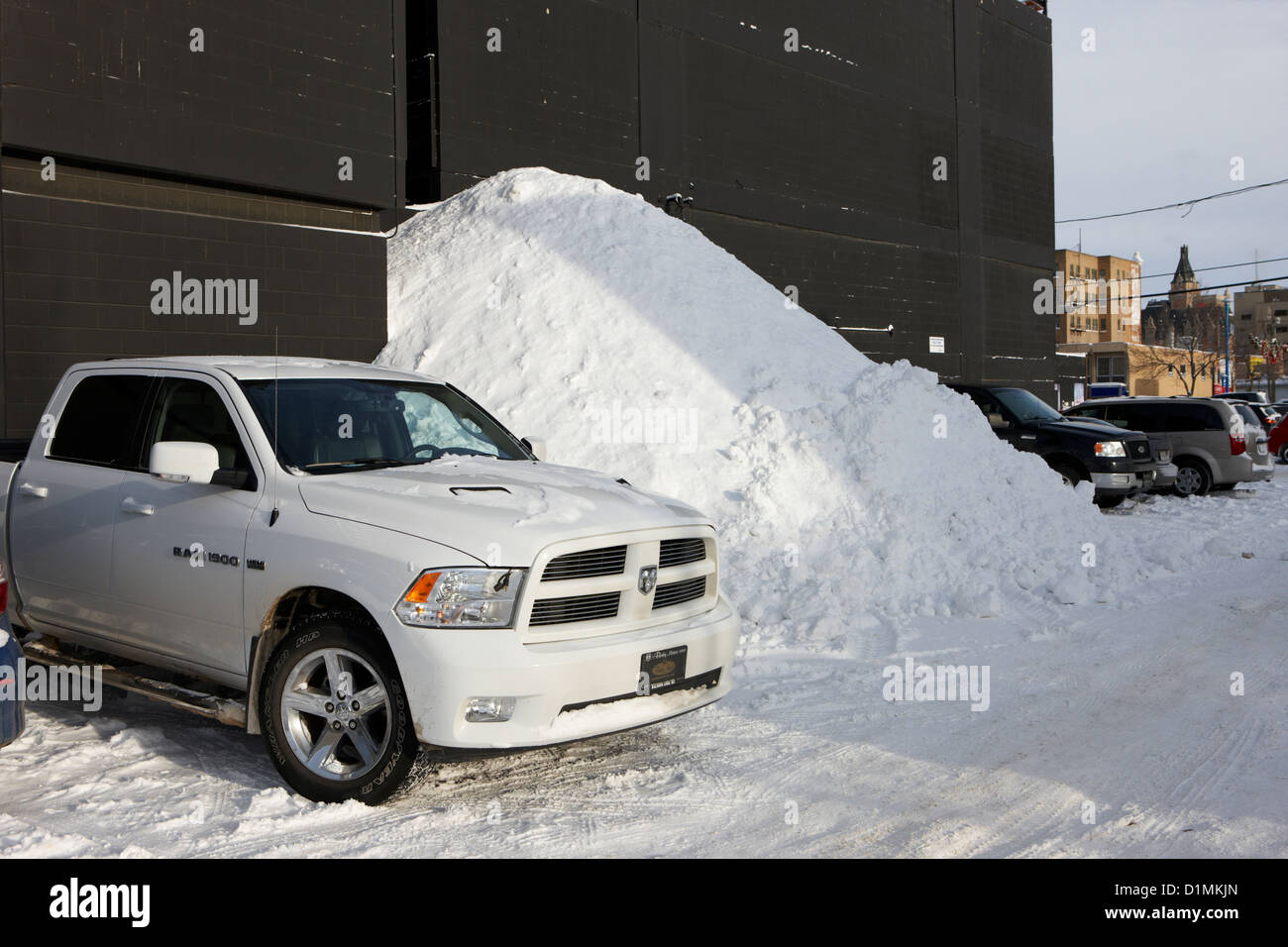 huge pile of snow cleared from parking lot in Saskatoon Saskatchewan Canada Stock Photo