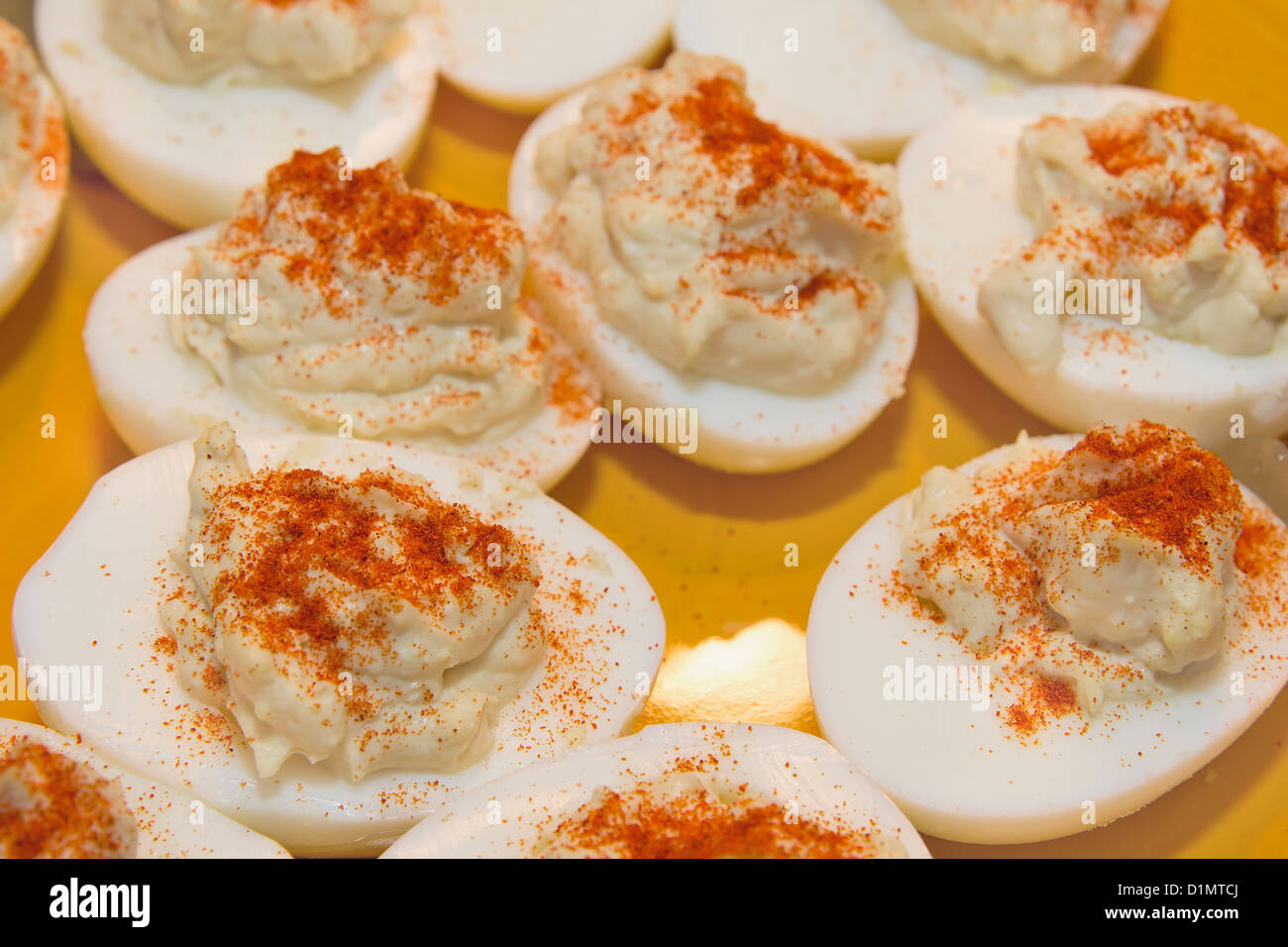 Plate of Deviled Eggs Hors D'Oeuvre sprinkled with Paprika Spice Closeup Stock Photo