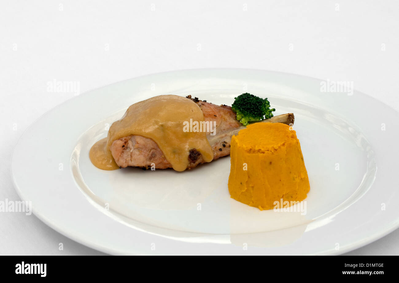 Pork Loin, served with a Roasted Pumpkin Timbale and Piquant Honey Sauce Stock Photo